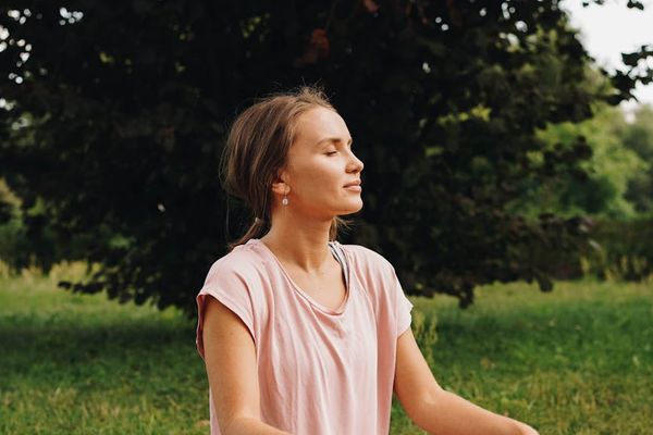 Person practicing deep, mindful breathing with eyes closed.
